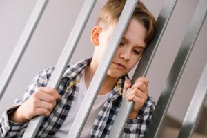 Sad Young Boy Leans On Metal Railings 2026 03 17 20 19 37 Utc